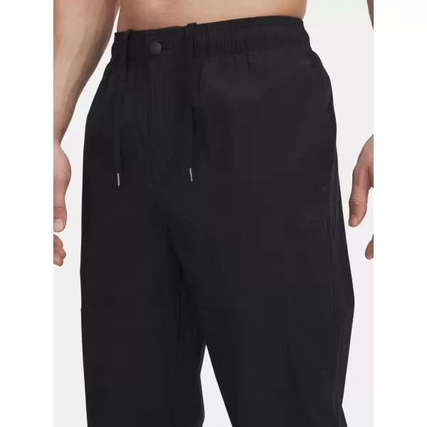  Pánske športové nohavice UNDER ARMOUR UA UNSTPBLE WOVEN TX TAPER 6003865-001 ČIERNA 